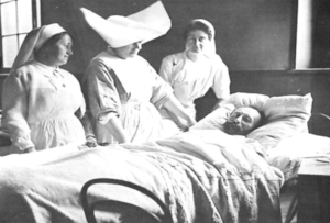 Infirmières au chevet d'un malade